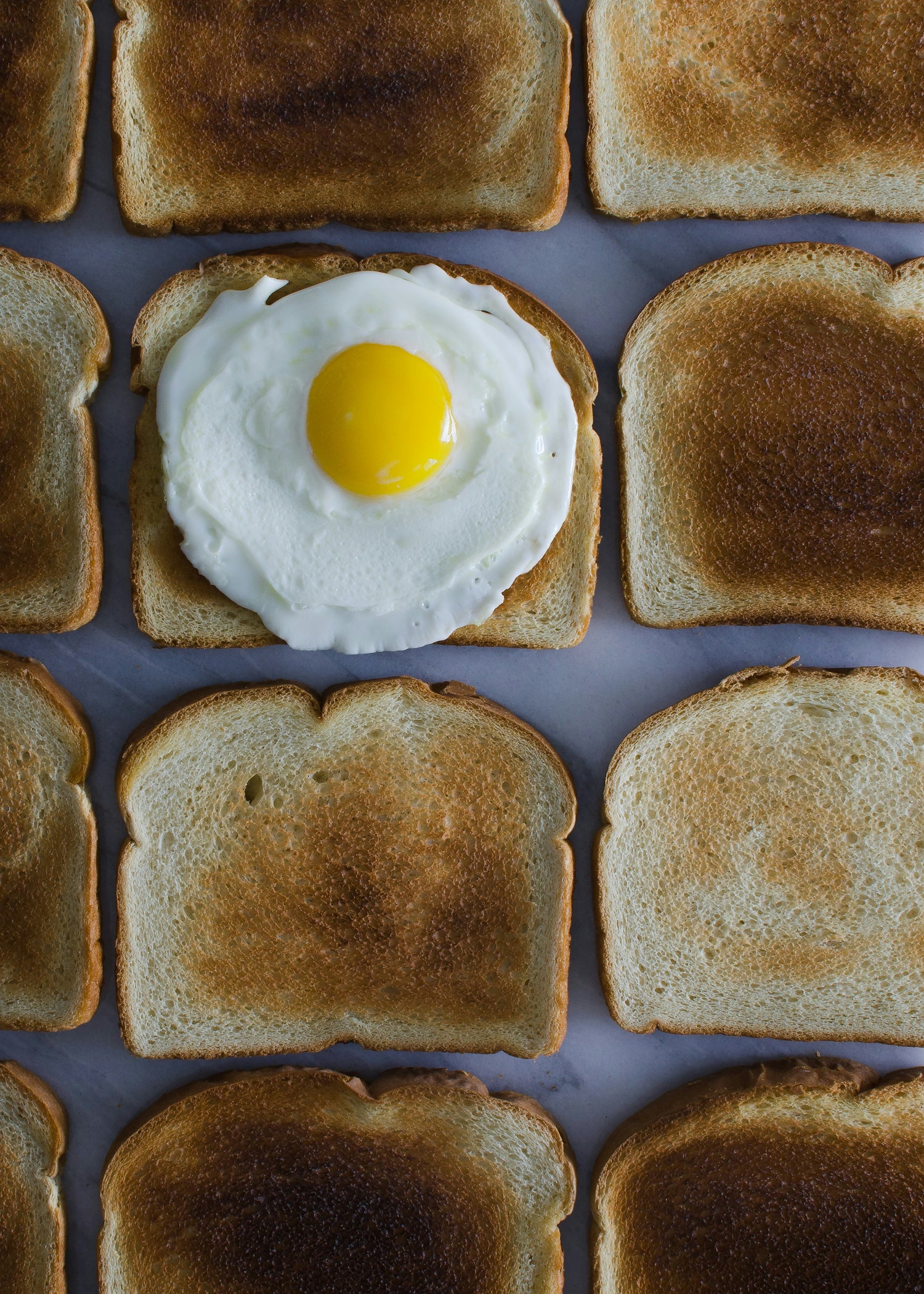 A sunny-side-up egg served on toasted bread, a popular breakfast dish that might need to be replaced with egg-free alternatives for those managing intolerance.