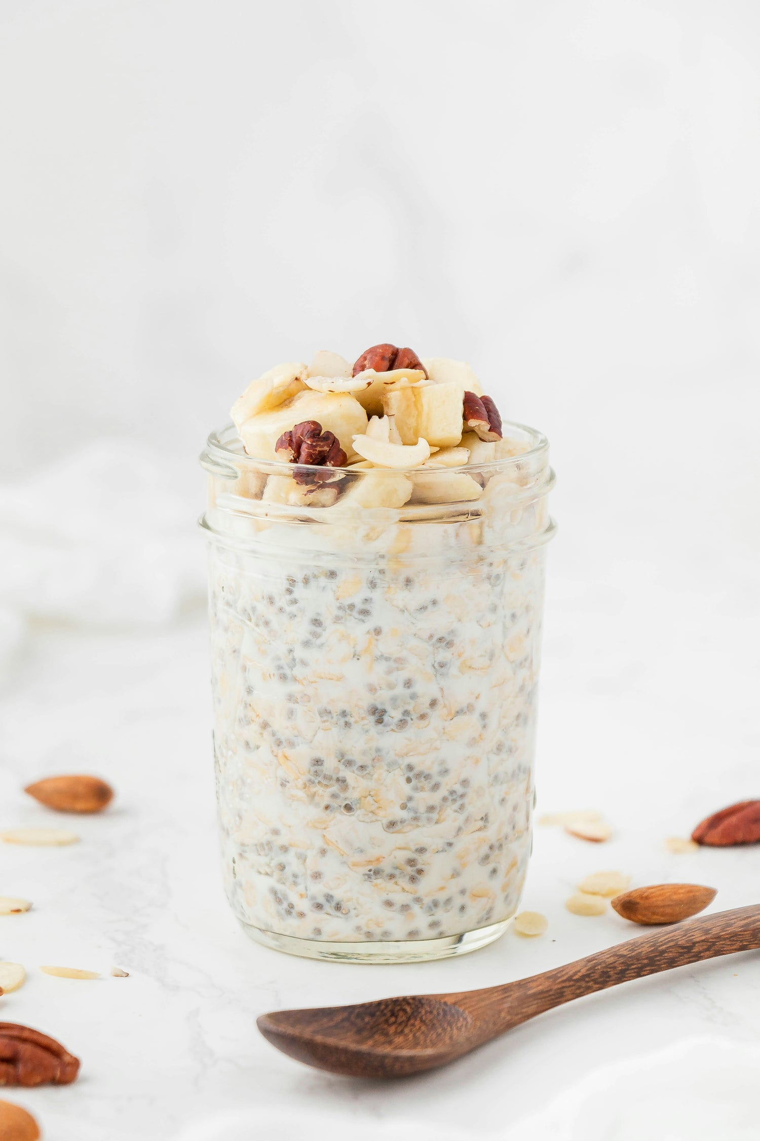 A glass jar filled with oatmeal and nuts, representing overnight oats as a nutritious, egg-free breakfast alternative for individuals with egg intolerance.