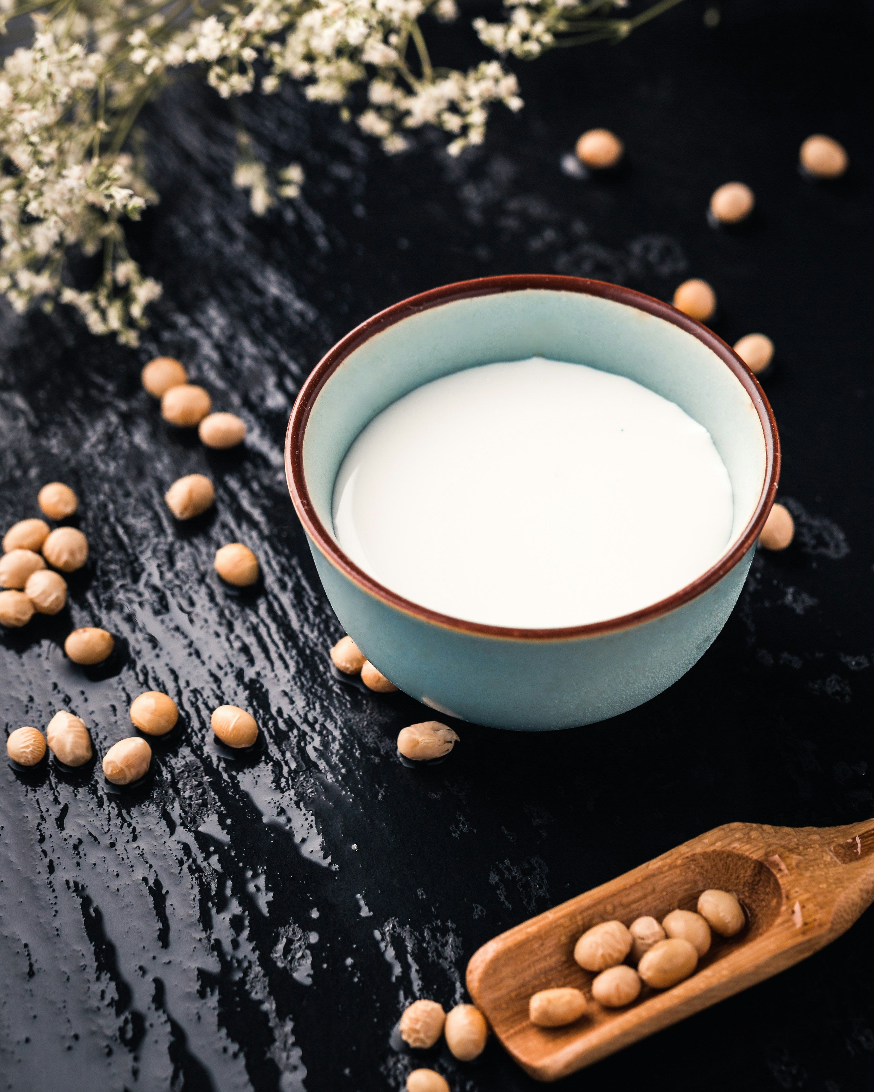 A bowl of white powder, symbolising soy milk, a widely used dairy-free alternative in Asian cultures where dairy consumption is traditionally low.